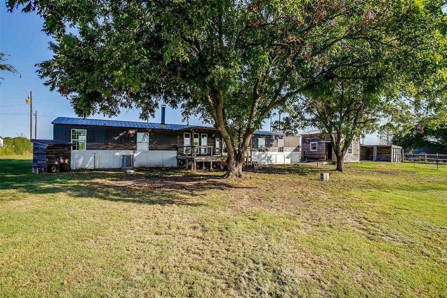 Rear view of property with a lawn