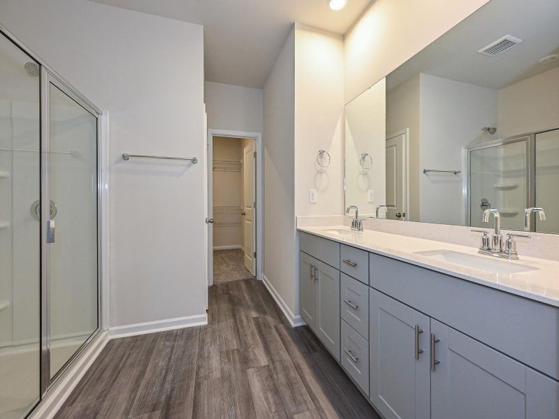 The primary bath offers dual vanity sinks and walk-in shower.