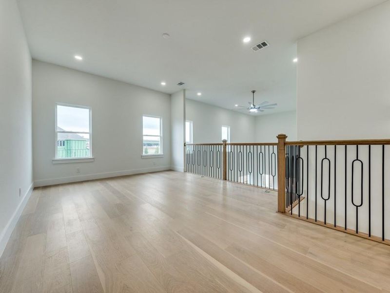 Spare room featuring ceiling fan and light hardwood / wood-style flooring