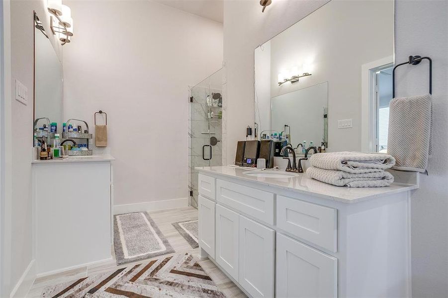 Ensuite bath with double vanities, plenty of cabinet space, beautifully tiled shower