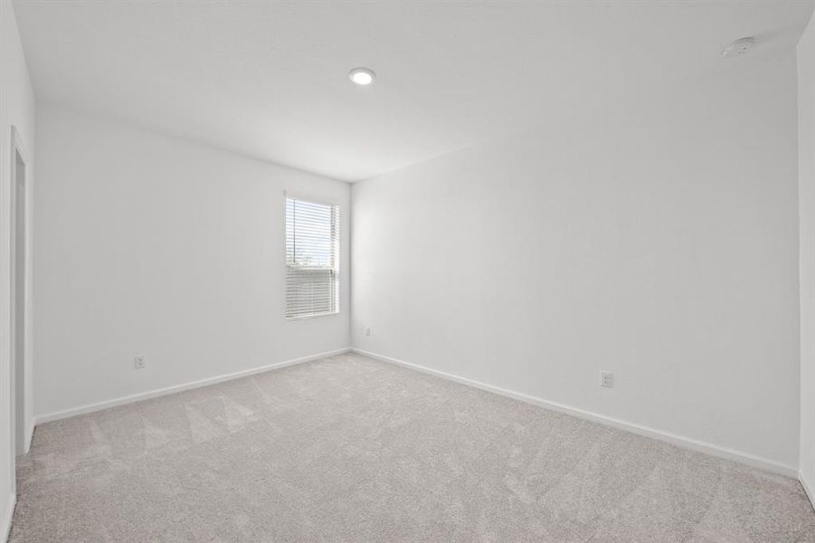 Bedroom 4 has walk-in closet with Wood blinds and carpet and recessed lighting