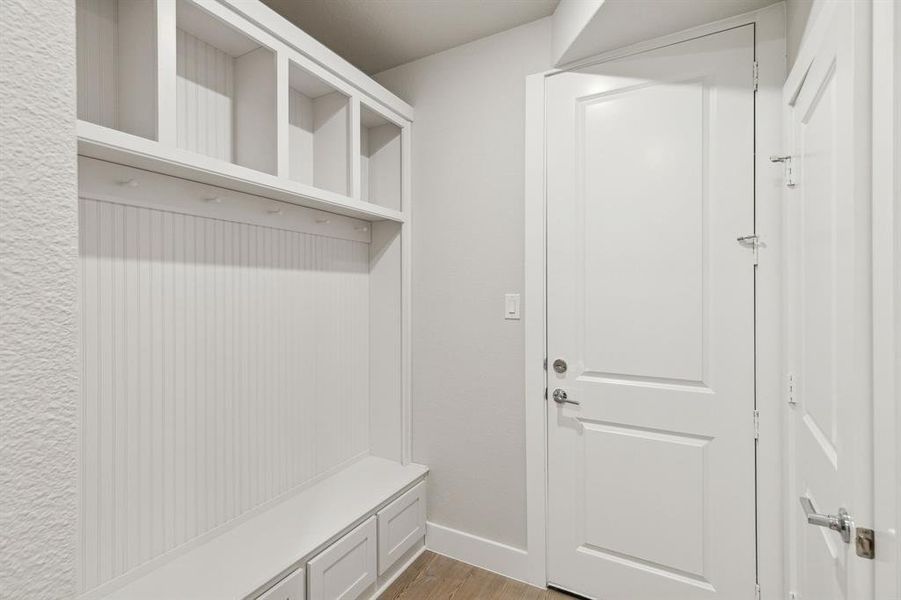 Mudroom with hardwood / wood-style flooring