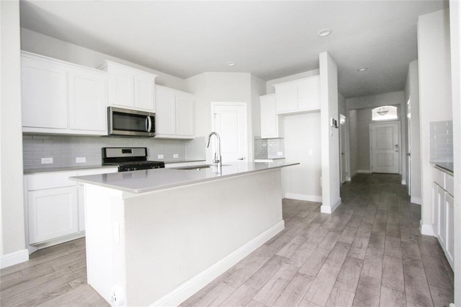 Imagine family gatherings in this open kitchen in the center of the home.