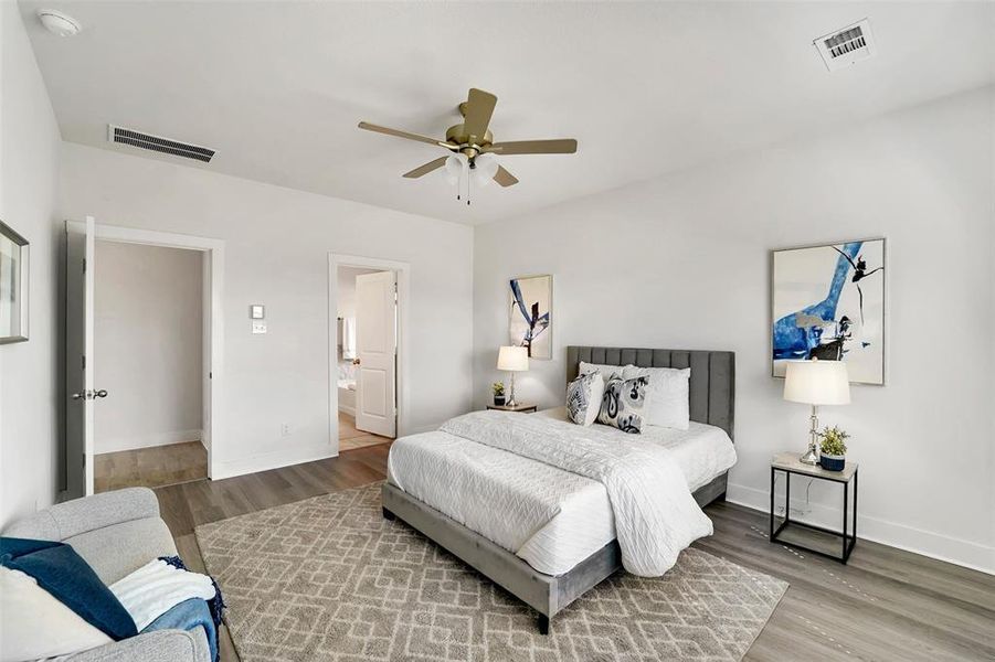 Bedroom featuring hardwood / wood-style floors, ensuite bath, and ceiling fan