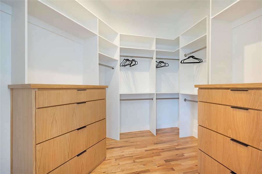 Spacious closet with light hardwood / wood-style floors