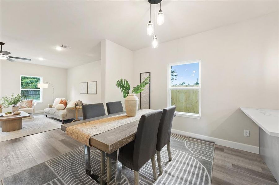 This is a bright, modern open-plan living and dining space with clean lines, featuring a neutral color palette, contemporary furnishings, and ample natural light from large windows.