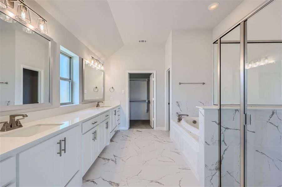 Bathroom featuring plus walk in shower, tile patterned flooring, and dual bowl vanity