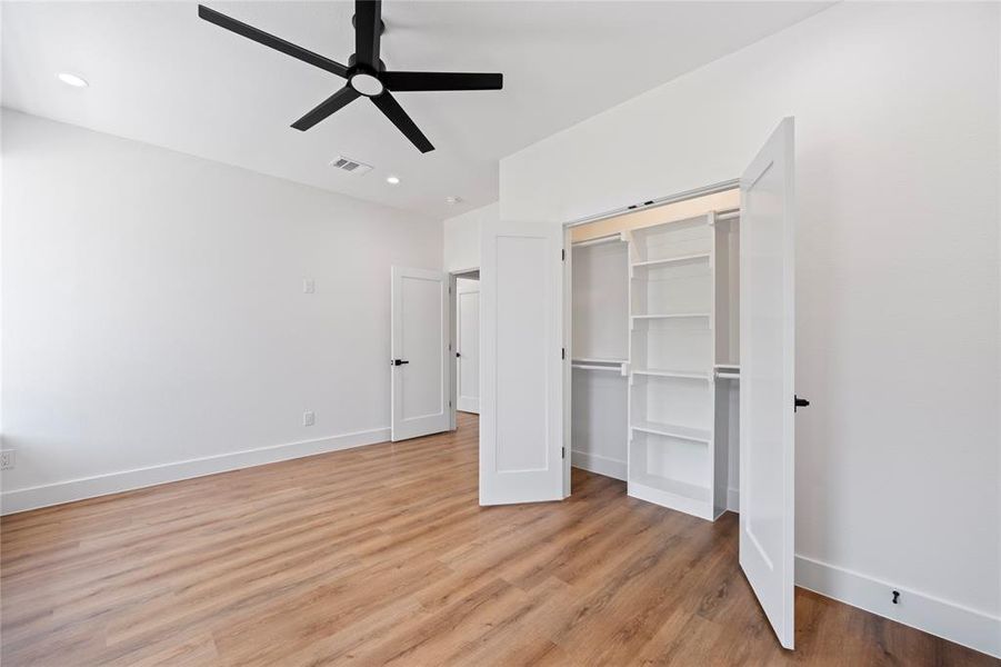 Unfurnished bedroom with light hardwood / wood-style floors, a closet, and ceiling fan
