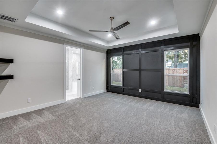 Massif Master bedroom with tray ceilings, shelves and accent wall!