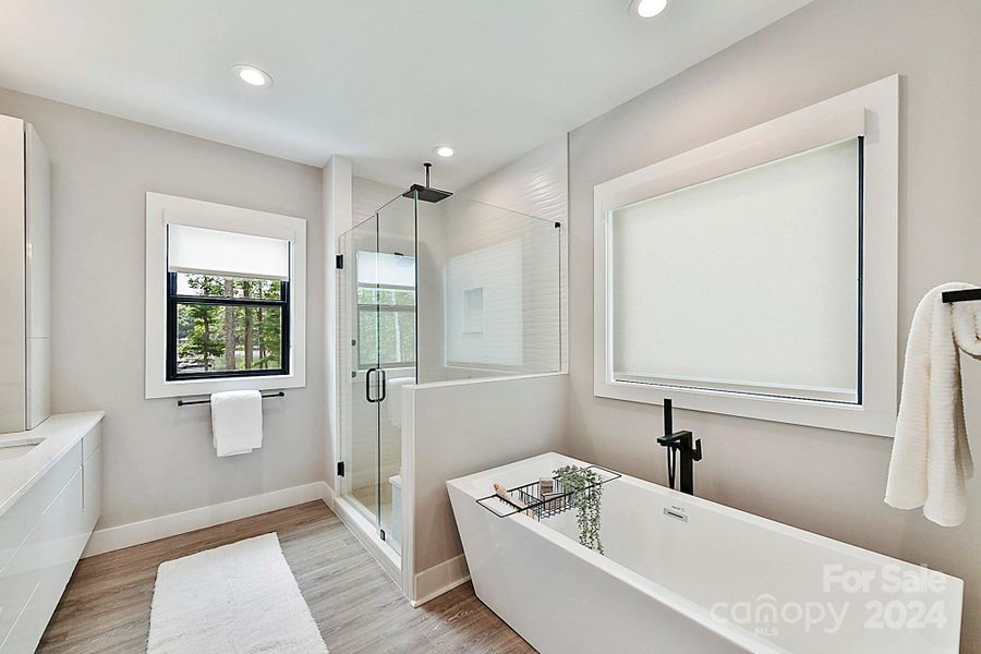 Luxury, Primary Bath with spa-like finishes including dual, quartz vanity, soaking tub, & separate, custom, tile/stone shower!