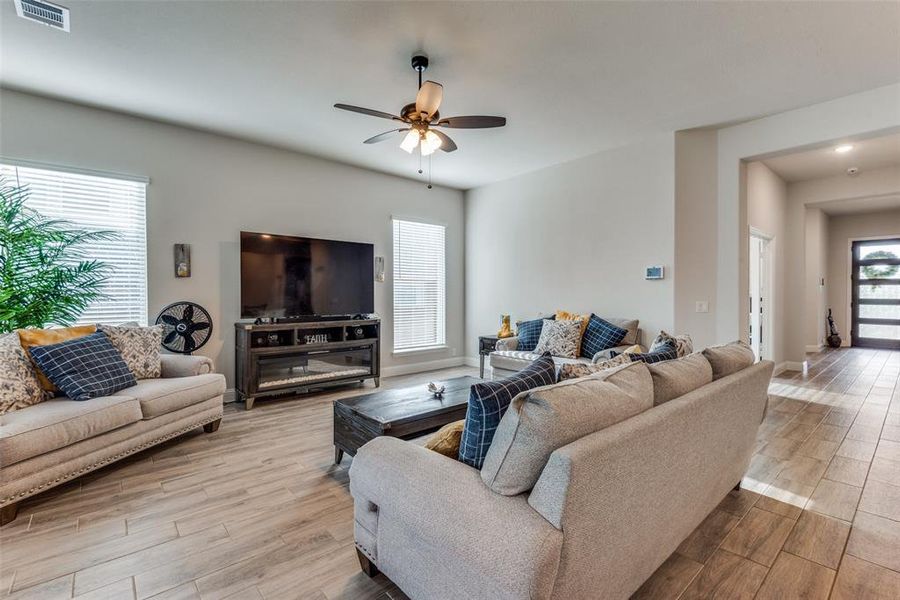 Living room featuring light hardwood / wood-style flooring and ceiling fan