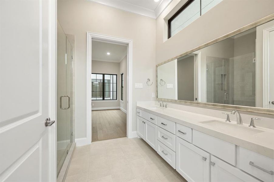 This master bathroom is definitely move-in ready! Featuring a walk-in shower, separate garden tub and light color cabinets with separate vanities.