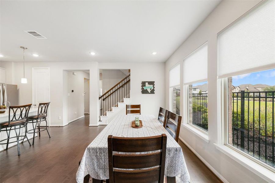 Another view of the eating area showing it's peaceful view of the side yard and open concept.