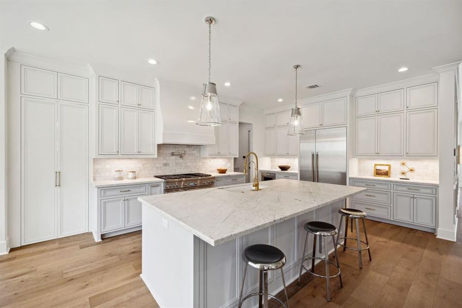 The double cabinet doors to the left lead you to an incredible "working pantry" you will not want to miss!