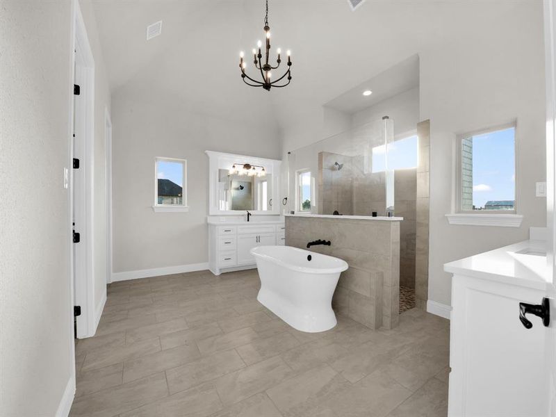 Bathroom featuring a healthy amount of sunlight, tile floors, and large vanity