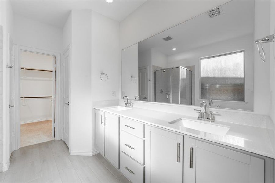 Bathroom with vanity and a shower with door