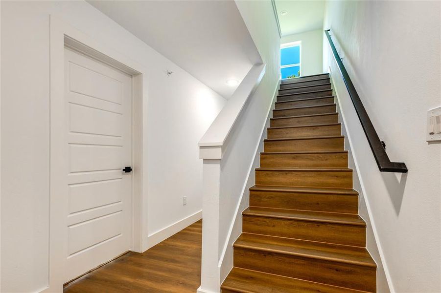 Stairway with hardwood / wood-style flooring