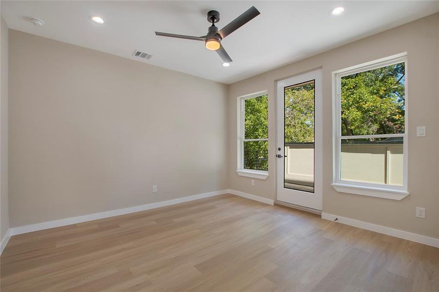 Unfurnished room with light wood-type flooring and ceiling fan