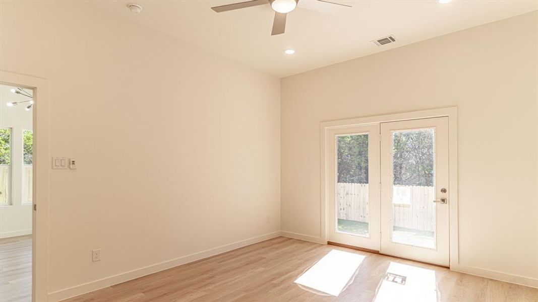 Primary bedroom with french doors to back patio