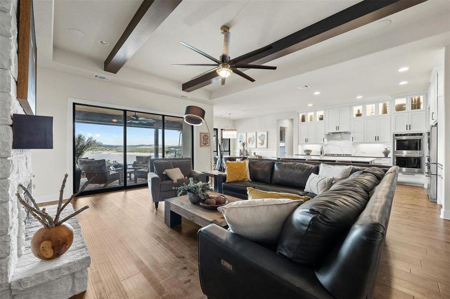 Warm wood flooring and ceiling beams create an inviting space for all your guests to relax in your spacious family room.