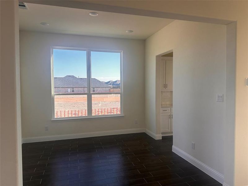 Spare room featuring dark hardwood / wood-style floors and a mountain view