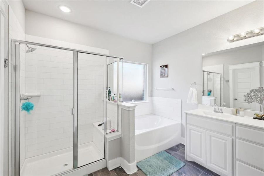 Bathroom with wood-type flooring, vanity, and independent shower and bath