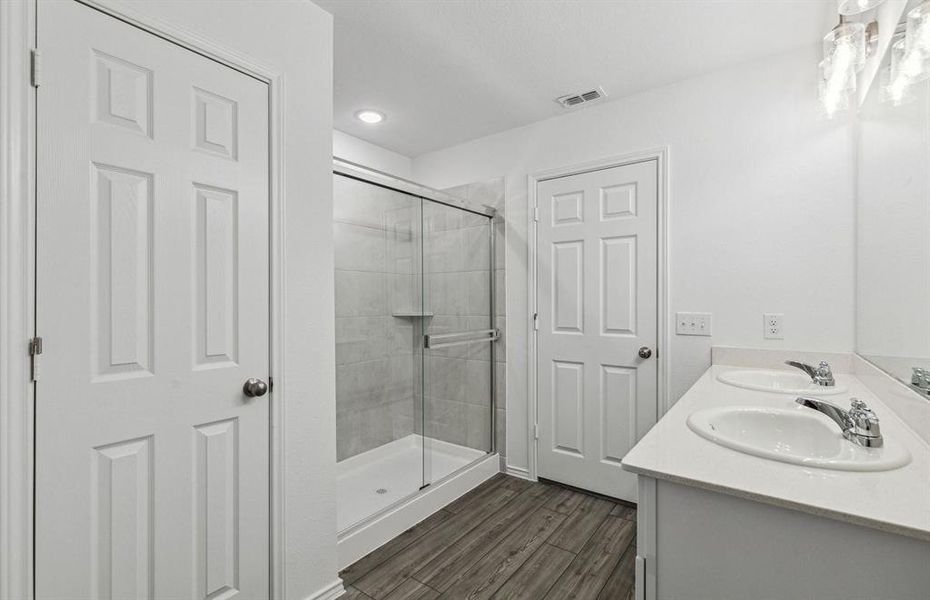 Owner's bath with dual vanity and oversized shower *model representation