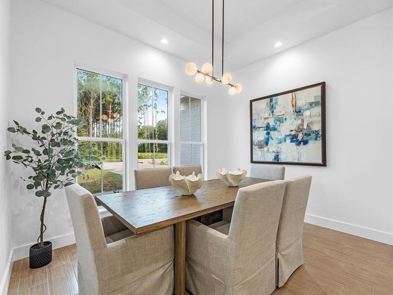 This formal dining space is perfectly sized, featuring large windows that enhance its ambiance.