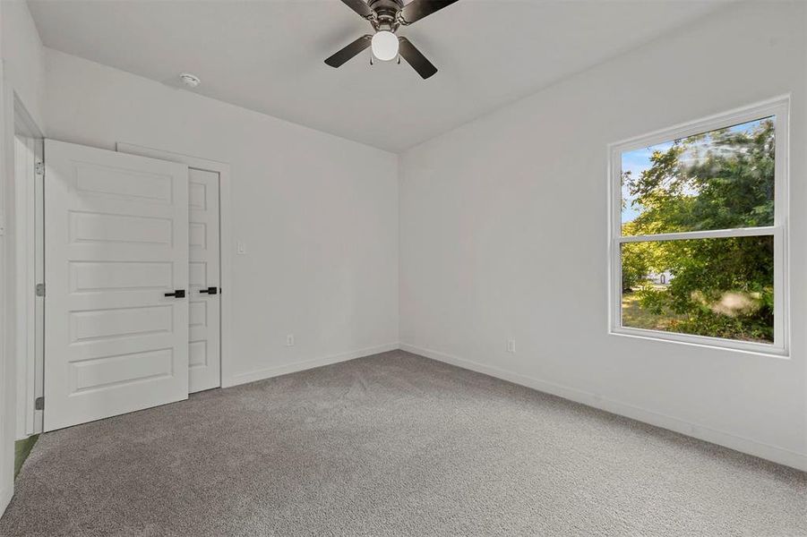 Spare room with carpet flooring and ceiling fan