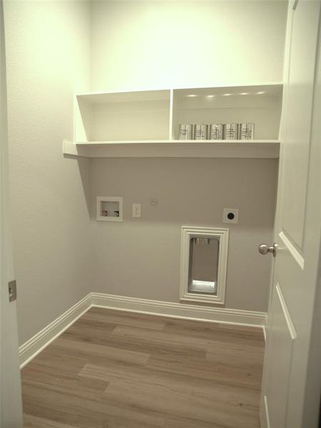 Washroom featuring hookup for a washing machine, hookup for a gas dryer, hardwood / wood-style floors, and hookup for an electric dryer