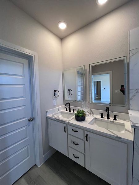 Bathroom with vanity and hardwood / wood-style floors