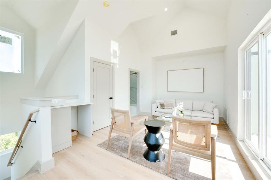 Bathroom with high vaulted ceiling and wood-type flooring