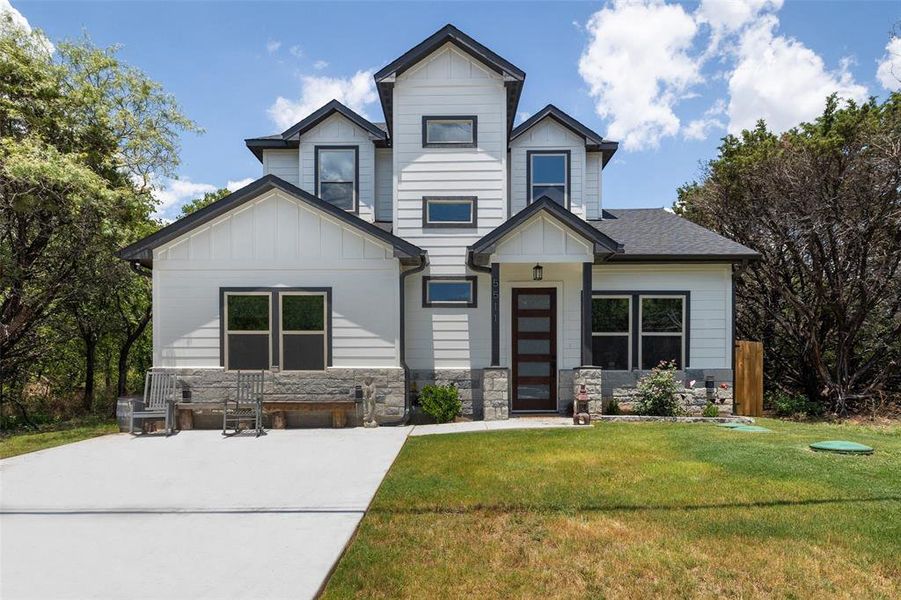 Craftsman-style home featuring a front lawn