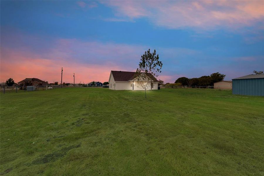 Yard at dusk with an outbuilding