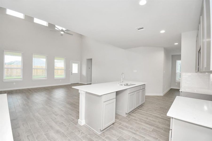 An extended counter area adds an extra layer of functionality. The open concept seamlessly connects this culinary haven to the expansive family room, creating the perfect hub for gatherings.