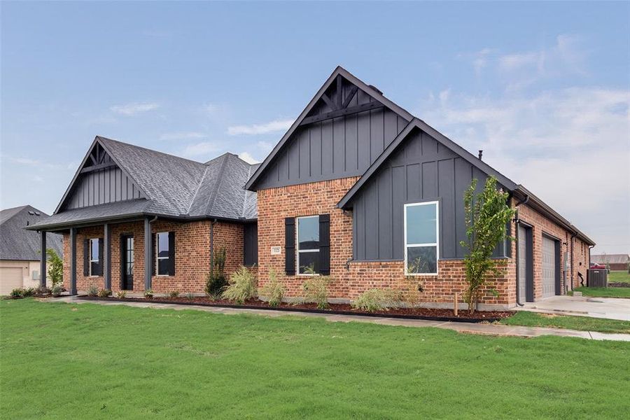 View of front of home featuring a garage and a front lawn