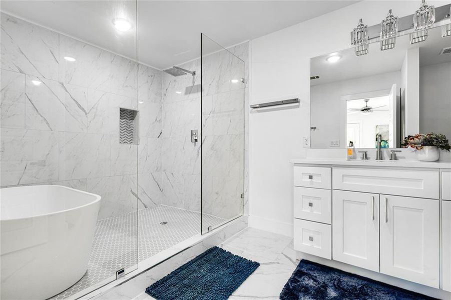 Bathroom featuring walk in shower, tile flooring, ceiling fan, and vanity