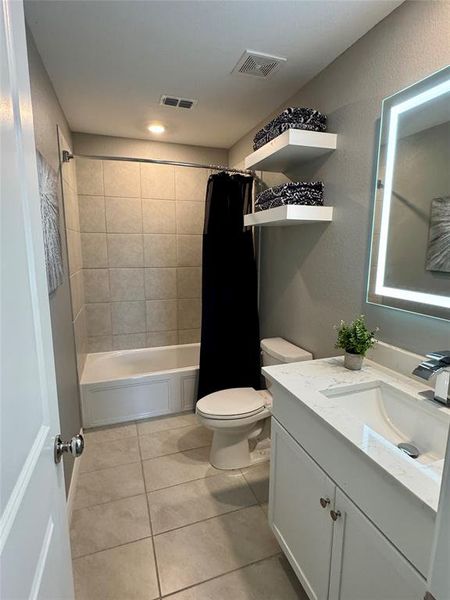 Bathroom 2 has quartz countertop and a backlit mirror.