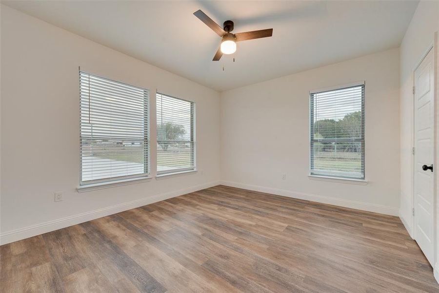 Unfurnished room featuring light hardwood / wood-style floors and ceiling fan