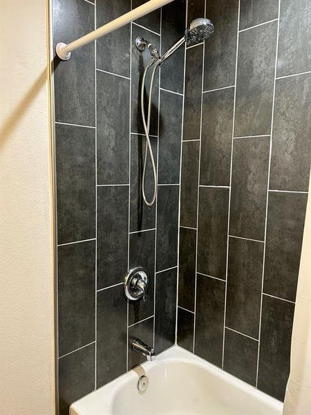 Bathroom with shower / bath combination with curtain