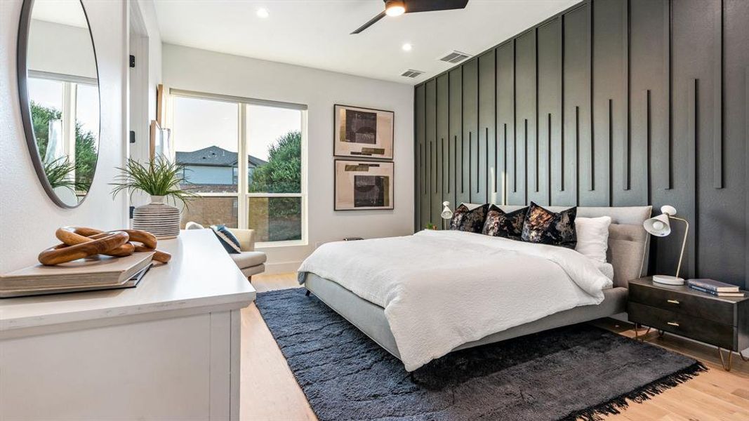 Bedroom featuring ceiling fan, light hardwood / wood-style floors, and multiple windows