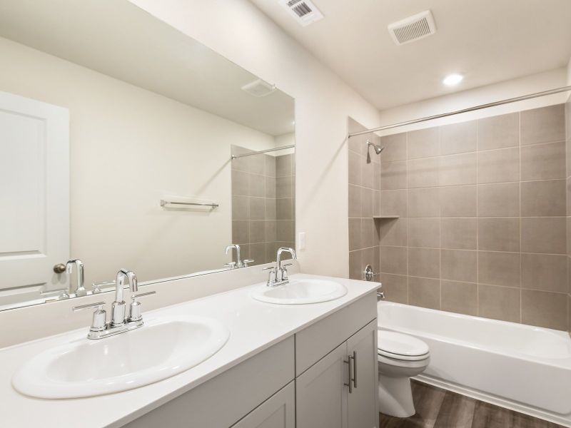 The upstairs secondary bathroom makes getting ready easier for everyone.