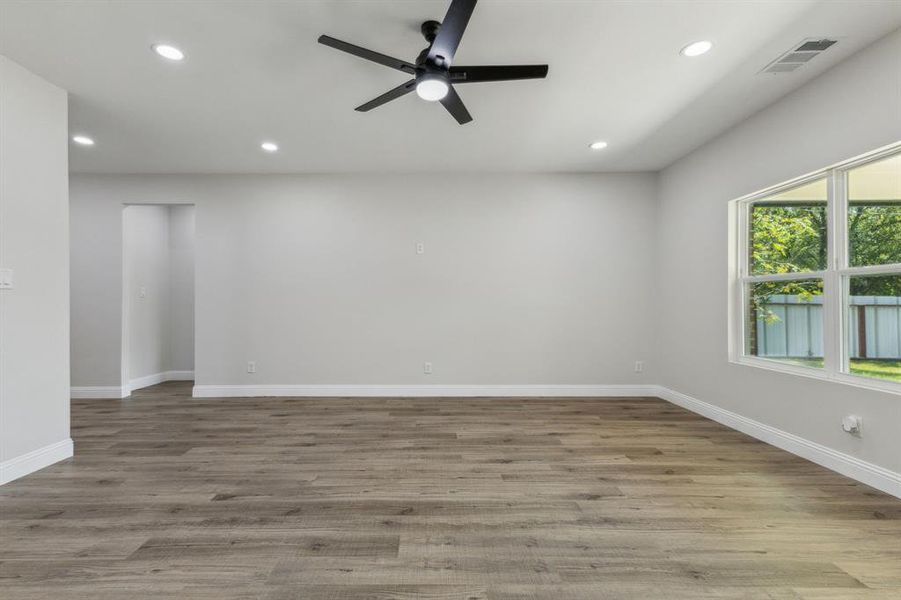 Unfurnished room with ceiling fan and light hardwood / wood-style flooring