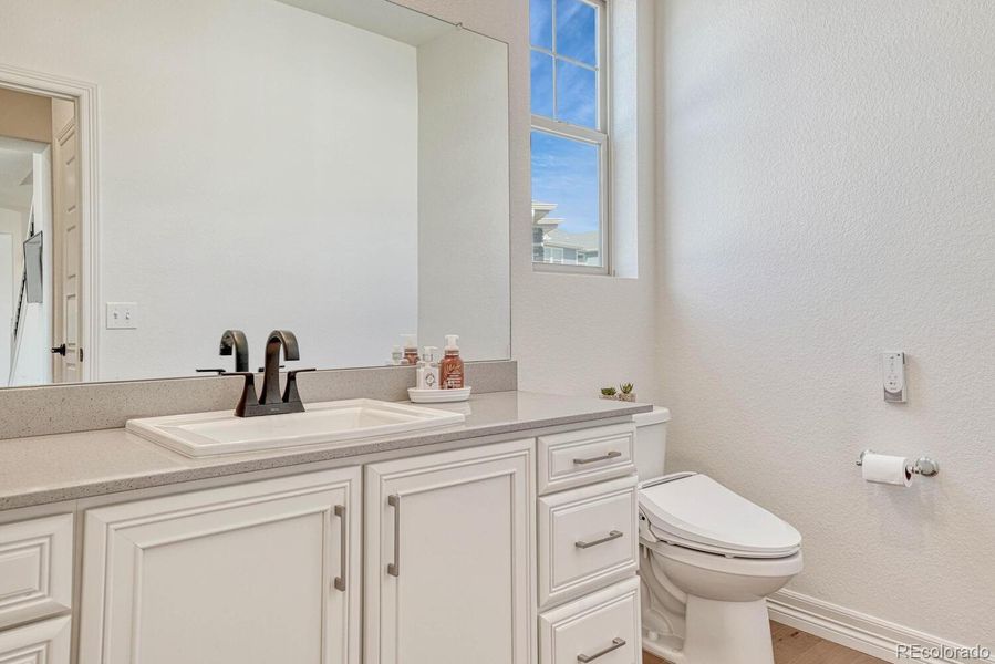 An elegant powder room equipped with a heated seat toilet.