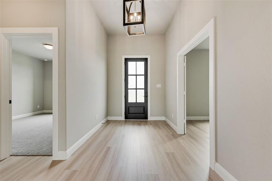 Entrance foyer with light wood-type flooring