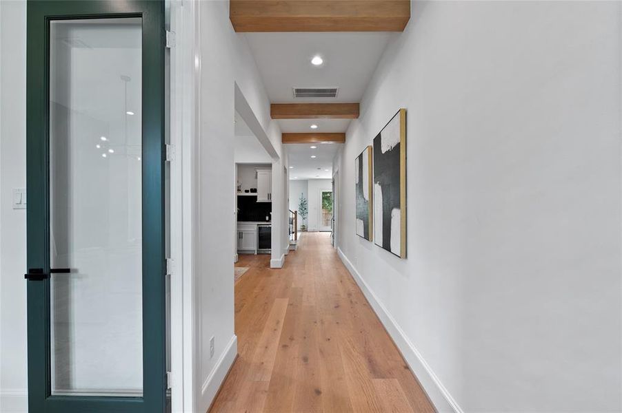 Graceful foyer with the office on the right and gorgeous ceiling beams that were stained to match the floors.