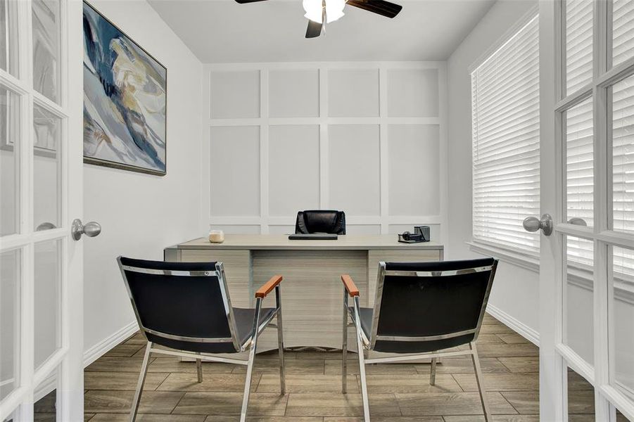 Office space featuring hardwood / wood-style flooring, ceiling fan, and french doors