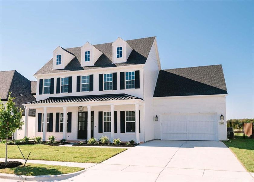 View of front facade with a front lawn, a porch, and a garage