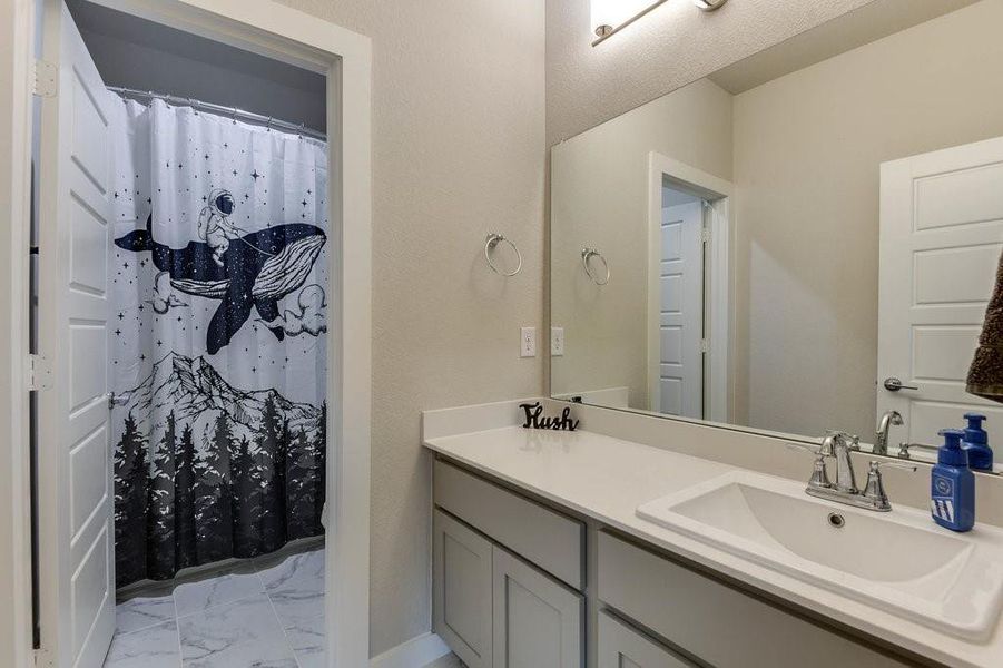 Secondary bathroom features separate dressing area.