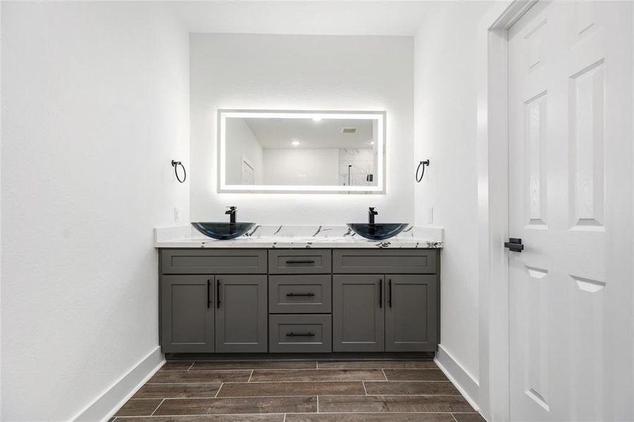 The Primary Bathroom has beautiful quartz counters and double vessel sinks